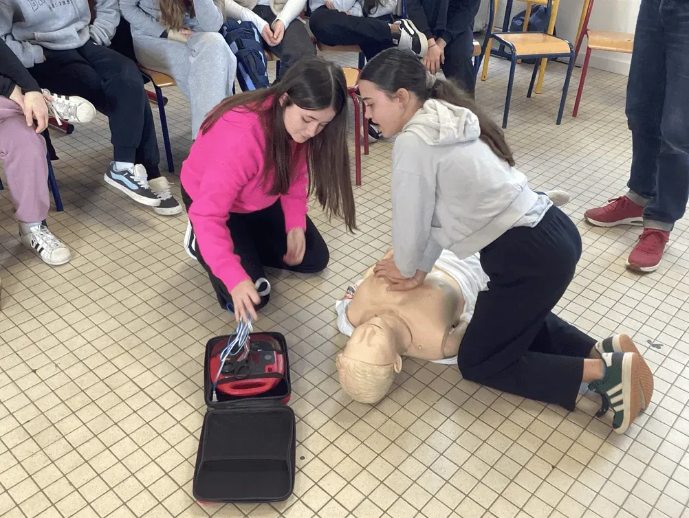 Deux élèves de 4ème pratiquant les gestes de premiers secours sur un mannequin.